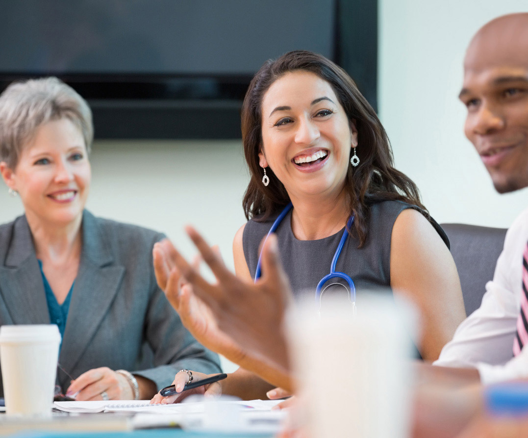 medical team laughing together at meeting
